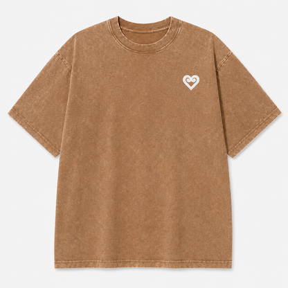 A brown acid-wash short-sleeve t-shirt with a small white heart logo on the left chest, displayed flat against a light gray background.