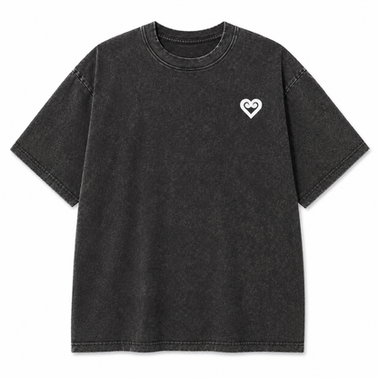 A dark gray acid-wash short-sleeve t-shirt with a small white heart logo on the left chest, displayed flat against a solid white background.