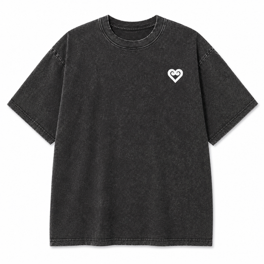 A dark gray acid-wash short-sleeve t-shirt with a small white heart logo on the left chest, displayed flat against a solid white background.