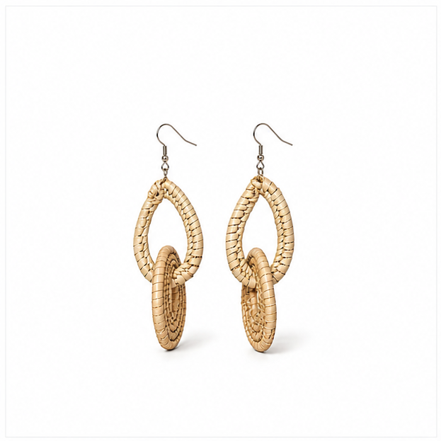 A pair of natural woven raffia or straw dangle earrings with interlocking teardrop and oval shapes, suspended from silver fishhook wires, shown on a plain white background.