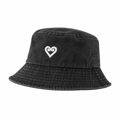 A washed black bucket hat featuring a white embroidered double-heart logo on the front, set against a plain white background.
