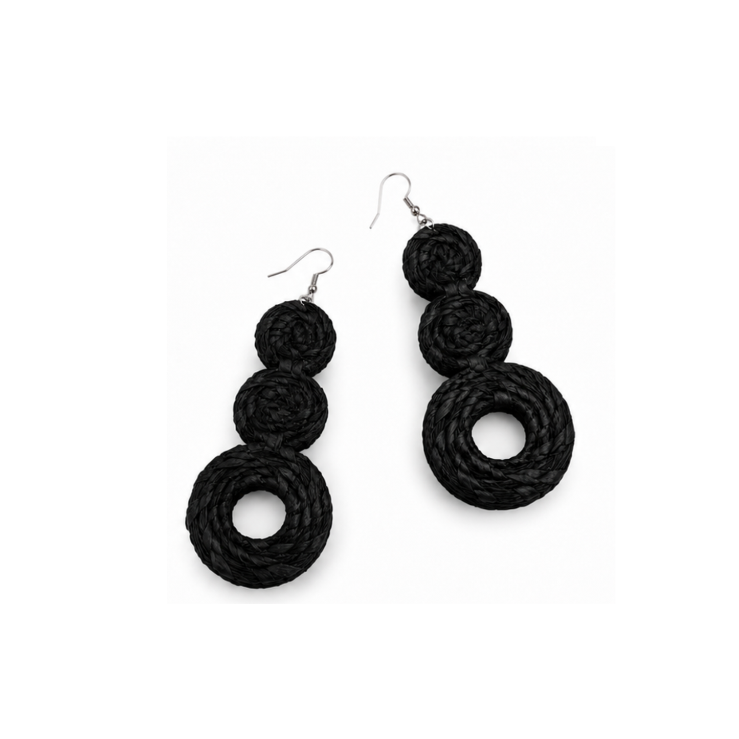 A pair of black raffia braided drop earrings with three stacked spiral rings on each earring, hanging from silver fishhook wires, shown against a plain white background.