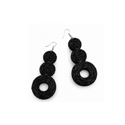 A pair of black raffia braided drop earrings with three stacked spiral rings on each earring, hanging from silver fishhook wires, shown against a plain white background.